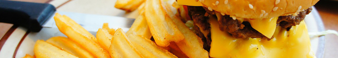 Eating Burger at Burgerland restaurant in Paris, TX.